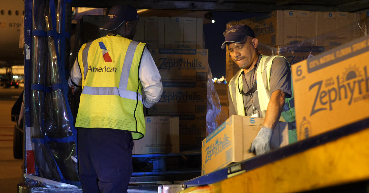 MIA team members load supplies on American's relief flight to the Bahamas