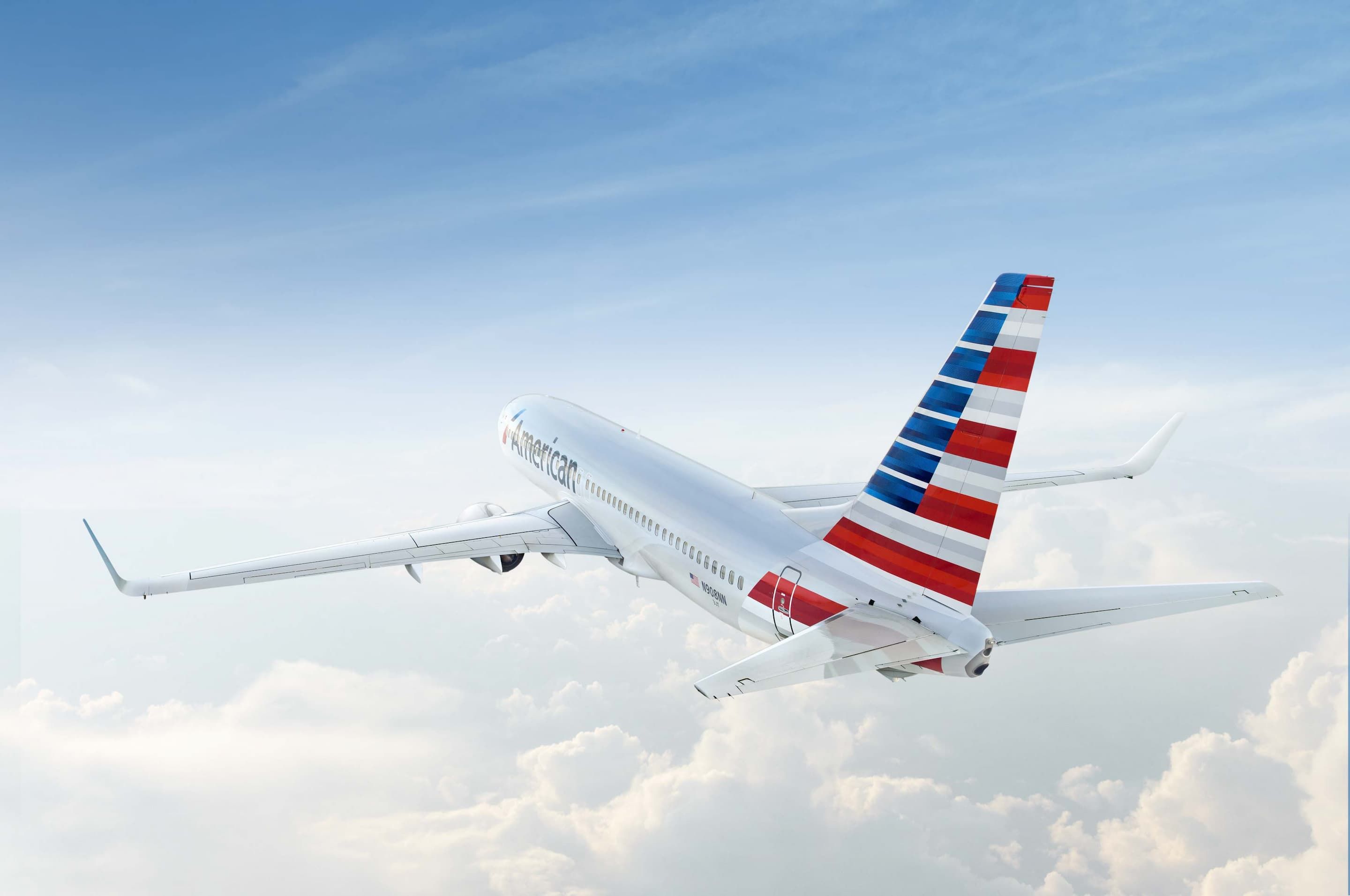 An American Airlines plane, flying high over the clouds