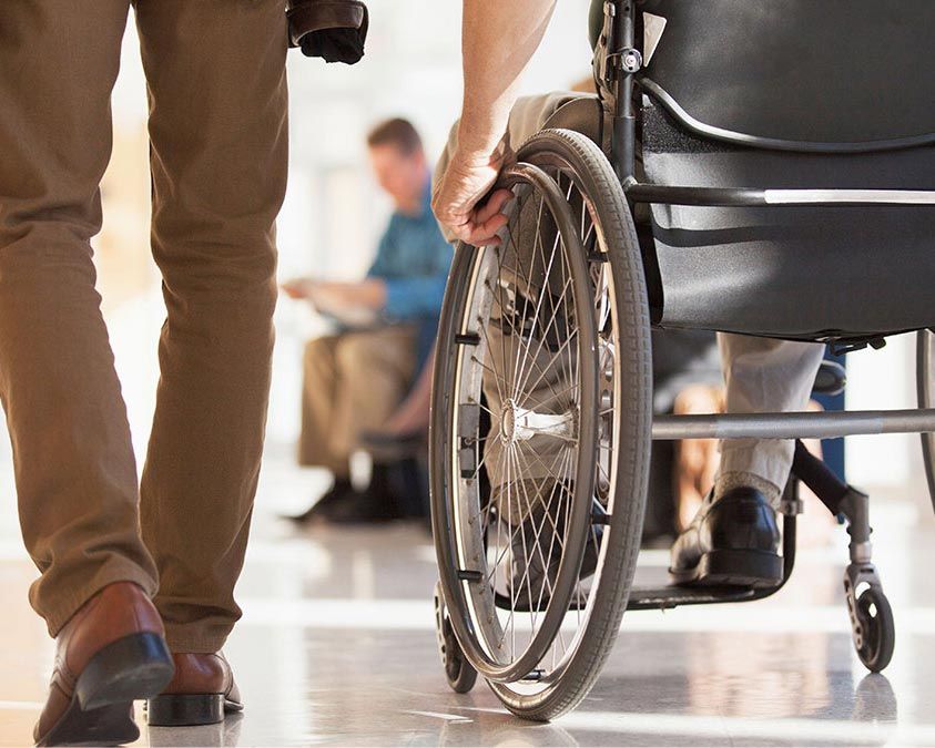 A person in a wheelchair, navigating through an airport